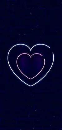 Looking for a live wallpaper that embodies moodiness and emotion? Look no further than this stunning image featuring a broken heart-shaped neon sign on a brick wall