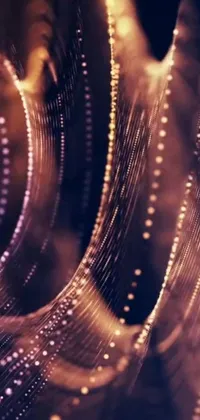 This phone live wallpaper features a close-up of water droplets on a glass surface, generative art, glowing wires, gold and purple tones, and a spiraling pattern
