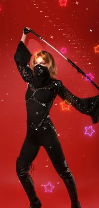 This live wallpaper features a powerful female warrior dressed in black leather armor, wielding a sword while standing confidently on a red background