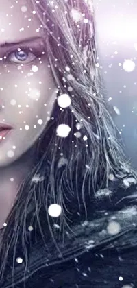 This phone live wallpaper displays a stunning image depicting a woman standing in the snow, with her hair flowing around her