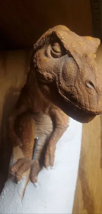 This live wallpaper features a detailed close-up of a toy dinosaur resting inside a wooden box on a table