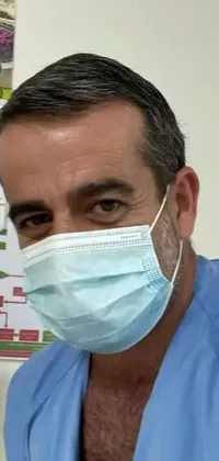 The phone live wallpaper depicts a middle-aged man wearing a surgical face mask, looking at his phone in front of a white calendar