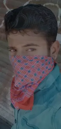 This live phone wallpaper features a close-up of a person wearing a bandana over their face