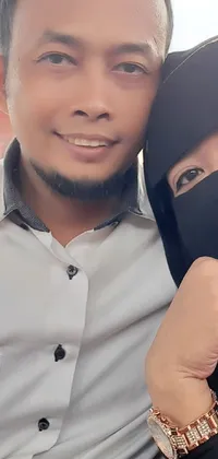 This stunning phone live wallpaper features a happy couple posing for a photo