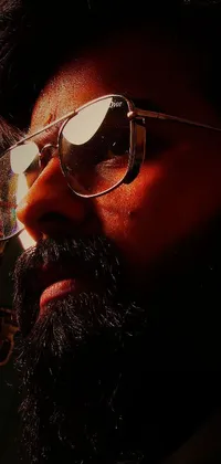 This phone live wallpaper features a close-up shot of a man wearing glasses and a beard, backlit to create a cinematic feel