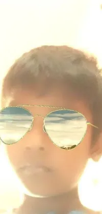 This phone live wallpaper features a close-up of a child wearing sunglasses