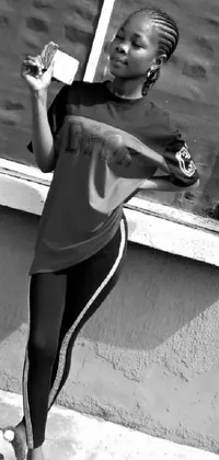 This phone live wallpaper showcases a striking black and white photograph featuring a sporty woman standing in front of a window holding a drink