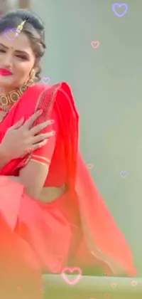This live wallpaper features a woman in a red sari, posing for a photograph or video