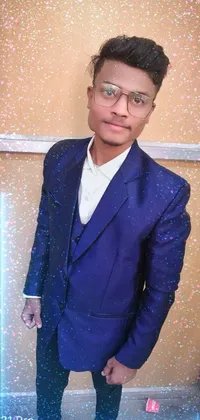 This live wallpaper showcases a youthful man in a stylish blue suit posing confidently against a trendy photo studio backdrop