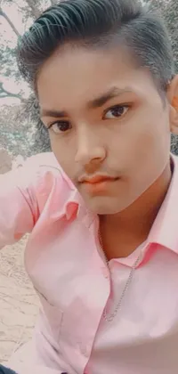 This phone live wallpaper showcases a close-up of a male teenager wearing a pink shirt in a tachisme style artwork by Rajesh Soni