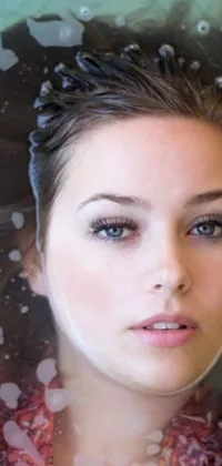 This stunning phone live wallpaper features a photorealistic close-up portrait of a person lying in a bathtub viewed through frosted glass, with a beautiful make-up on their face