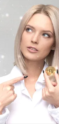 This phone live wallpaper showcases an eye-catching image of a blonde woman in a white shirt, holding a shimmering gold coin