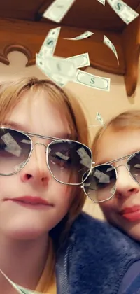 This stylish live wallpaper showcases two women wearing sunglasses and standing against a photo-realistic indoor background