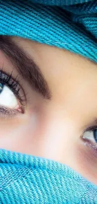 Looking for a stunning live wallpaper that captures the beauty of Arabian features? Check out this phone live wallpaper featuring a close up of two perfect blue eyes shimmering with shades of blue and a subtle sparkle