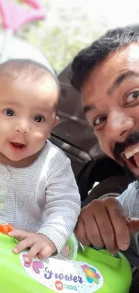 This captivating phone live wallpaper showcases an adorable moment between a man and a baby