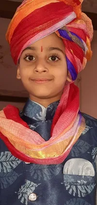 This phone live wallpaper showcases a stunningly detailed close-up of a child wearing a colorful, traditional turban inspired by Indian culture
