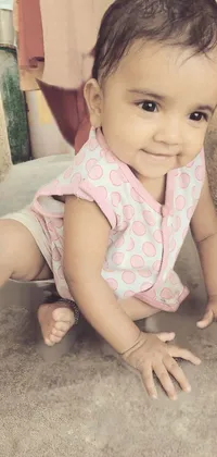 This live wallpaper features a cheerful and energetic baby girl crawling on a concrete floor