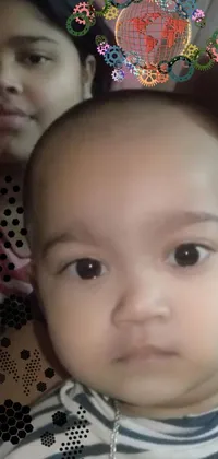 This phone live wallpaper showcases a close-up of a person cradling an adorable baby