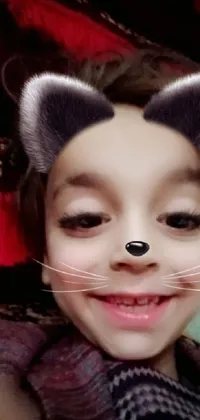 This phone live wallpaper features a close-up of a child wearing a cat mask