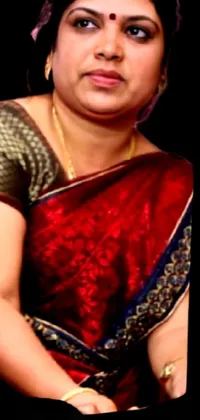 This phone live wallpaper features a stunning portrait of a woman in a red sari