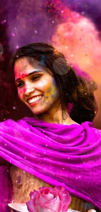 This live phone wallpaper depicts a woman throwing colored powder on her face, wearing a sari