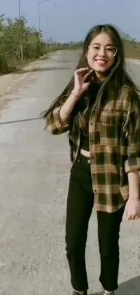 This phone live wallpaper showcases a casually dressed woman talking on a cellphone standing on the side of the road