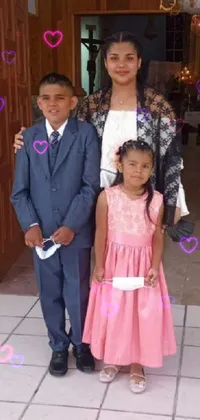 This live wallpaper features a charming scene of two young kids dressed in a light-pink suit and formal attire, respectively, standing beside one another