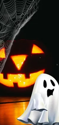 Looking for a spooky live wallpaper for your phone this Halloween season? Look no further than this photorealistic image featuring a ghost standing in front of a Halloween pumpkin