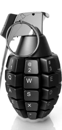 This phone live wallpaper features a striking design of a black hand grenade on top of a keyboard