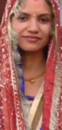 This stunning phone live wallpaper showcases a beautiful close-up of a woman in a traditional red veil, wearing a gorgeous wedding gown and smiling