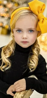 Introducing a stunning phone live wallpaper featuring a cute little girl wearing a stylish headband and a big yellow bow