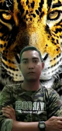 This phone live wallpaper is an exciting and adventurous image that features a man standing in front of a majestic tiger