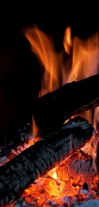 This phone live wallpaper boasts a mesmerizing and highly detailed 8k close-up of a fireplace, complete with dancing and flickering bright flames creating a warm ambience