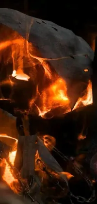 This brilliant live phone wallpaper showcases a realistic close-up of flames with orange and yellow hues wild-lit moving impressively to create a brilliant fire display