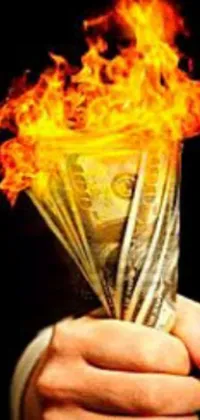 This phone live wallpaper showcases a flaming fist clenching money, radiating an intense and fiery image