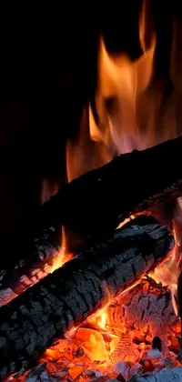 The Phone Live Wallpaper depicts an alluring and highly detailed close-up shot of a crackling fire in a fireplace, available in 8k resolution