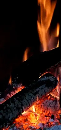 This mesmerizing phone live wallpaper showcases an ultra-realistic 8k close-up of a blazing fire in a fireplace