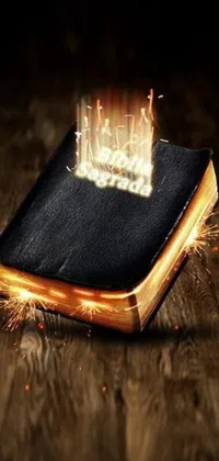 This live phone wallpaper showcases a stunning digital rendering of a burning bible resting on a wooden floor