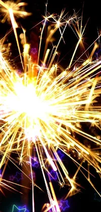 This live wallpaper for your phone features a captivating close-up of a sparkler against a dark background