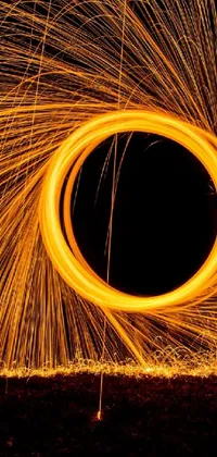Immerse yourself in an industrial world with this captivating live wallpaper for your phone! A mesmerizing ring of steel wool spins furiously in the dark against an outdoor photo, with orange neon backlighting creating a striking contrast