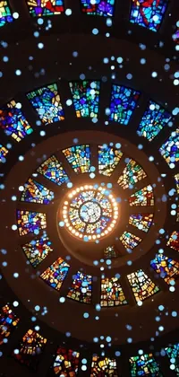Experience the mesmerizing beauty of a circular stained glass window in this phone live wallpaper