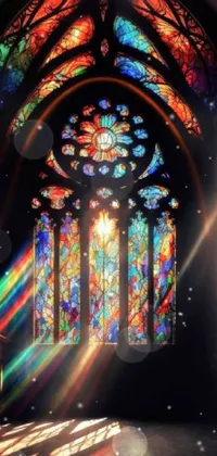 This live phone wallpaper features a stunning stained glass window in a gothic-style church