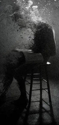 This live phone wallpaper showcases a striking black and white photograph of a person seated on a chair