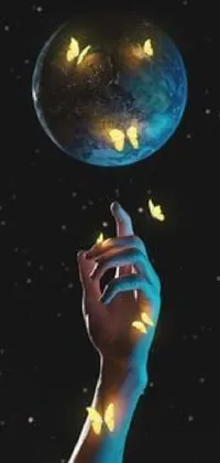 This phone live wallpaper features a hand reaching towards a glowing Earth, complemented by an album cover, glowing butterflies, phosphorescent flowers, and shooting stars