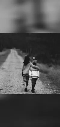 This live wallpaper boasts a stunning black and white photo of two little girls walking down a dirt road