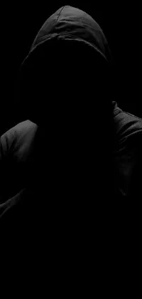 This live wallpaper features a striking black and white photo of a mysterious person wearing a hoodie in the dark