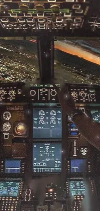 This live phone wallpaper depicts a cockpit view of a plane flying at night