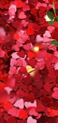 This beautiful live wallpaper features red and pink heart-shaped confetti in a pointillism style