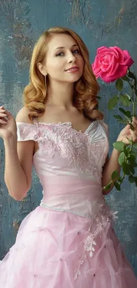 This is a stunning live wallpaper that features an elegant portrait of a graceful woman in a pink dress holding a rose