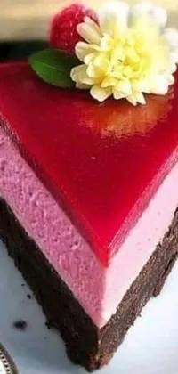 This phone live wallpaper features a pink and red piece of cake on a white plate
